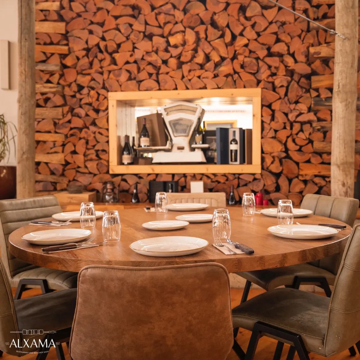 Dining room with fireplace at ALXAMA steakhouse Quarteira — reserve your table in the Algarve