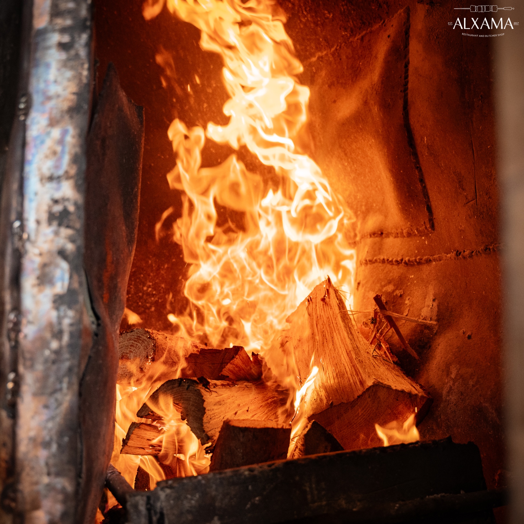 Wood fire embers at Alxama restaurant - authentic wood-fired grilling in Algarve